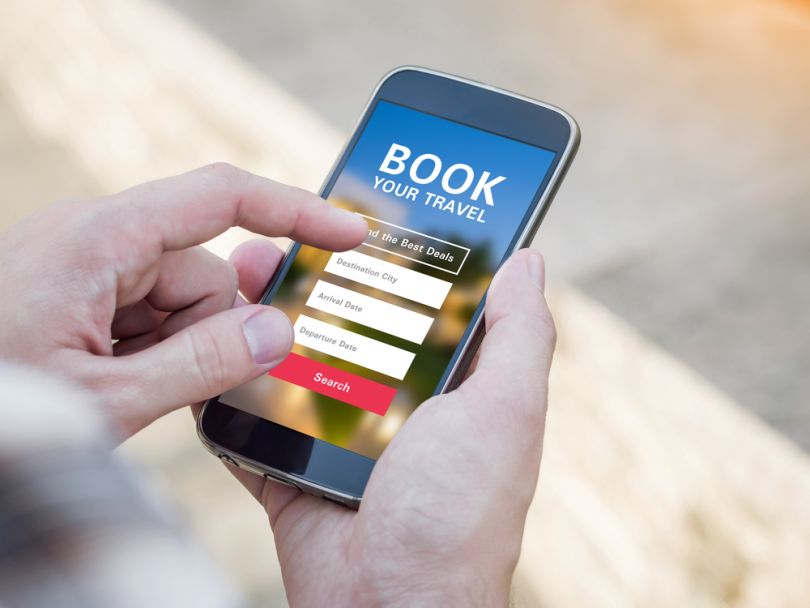 hands with smartphone with booking website open