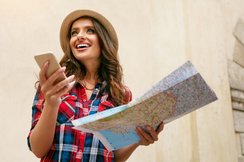 girl with map and smartphone