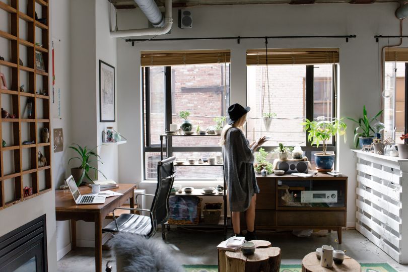 Girl in an apartment full of plants