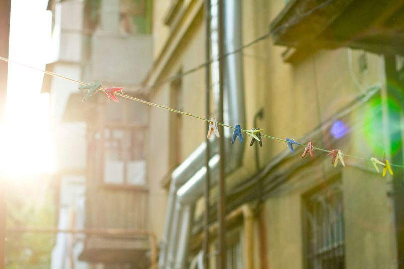 old building in sunbeams, rope with pins in front