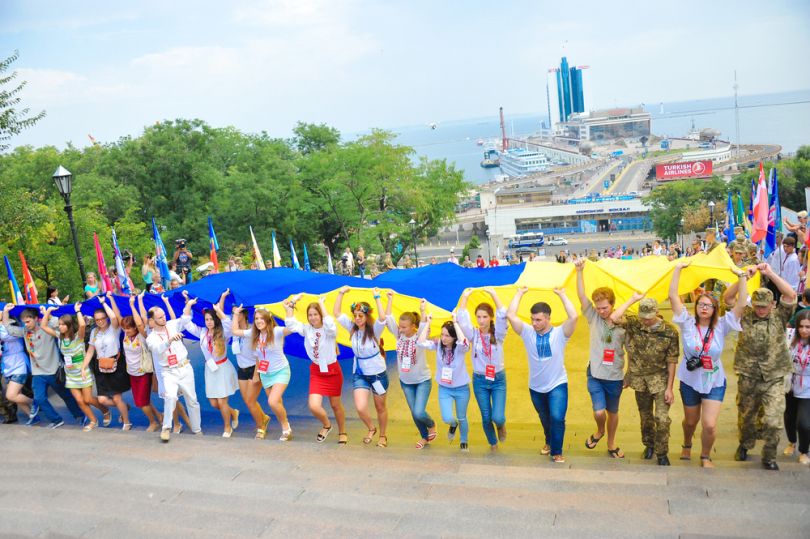 people carrying large ukrainian flag on potemkin stairs in odesa