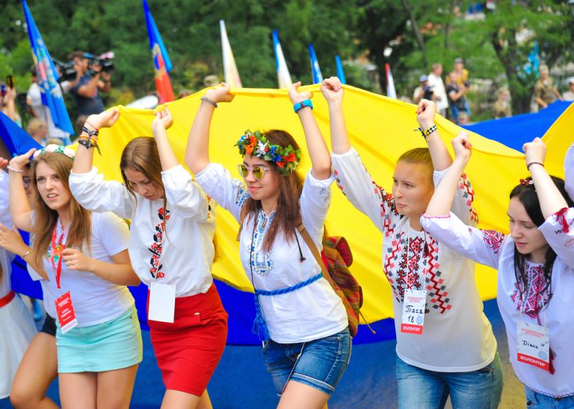 People in vyshyvanka carry a huge Ukrainian flag