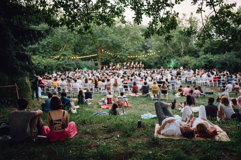 People chilling and listening to music in a garden