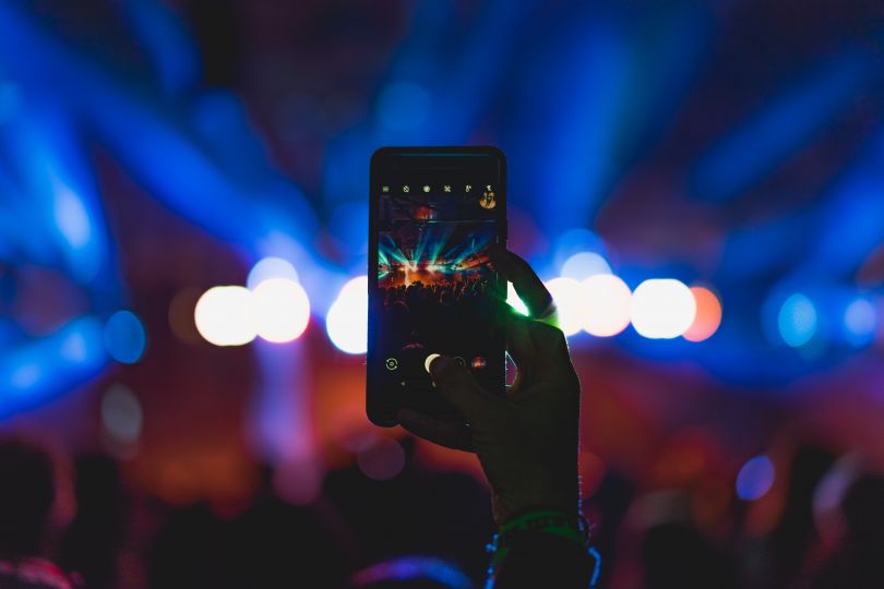 Person holding a phone on the concert