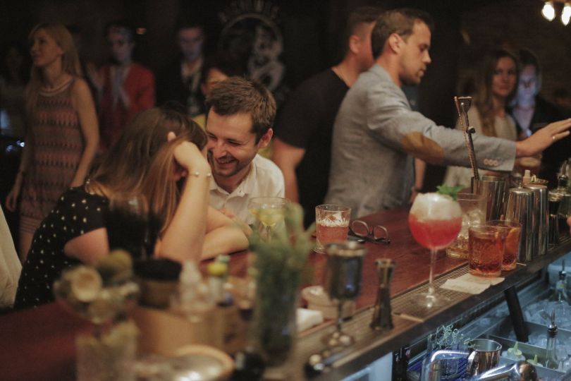 people having cocktails at bar counter