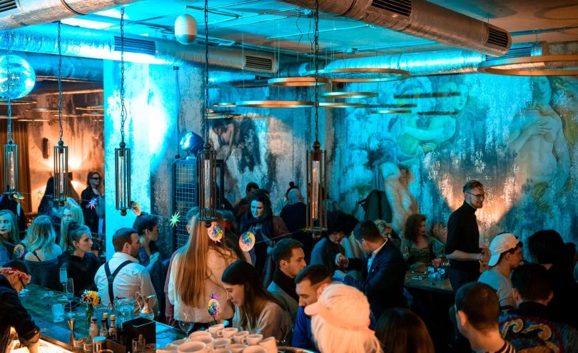 crowd in bar with stylish interior