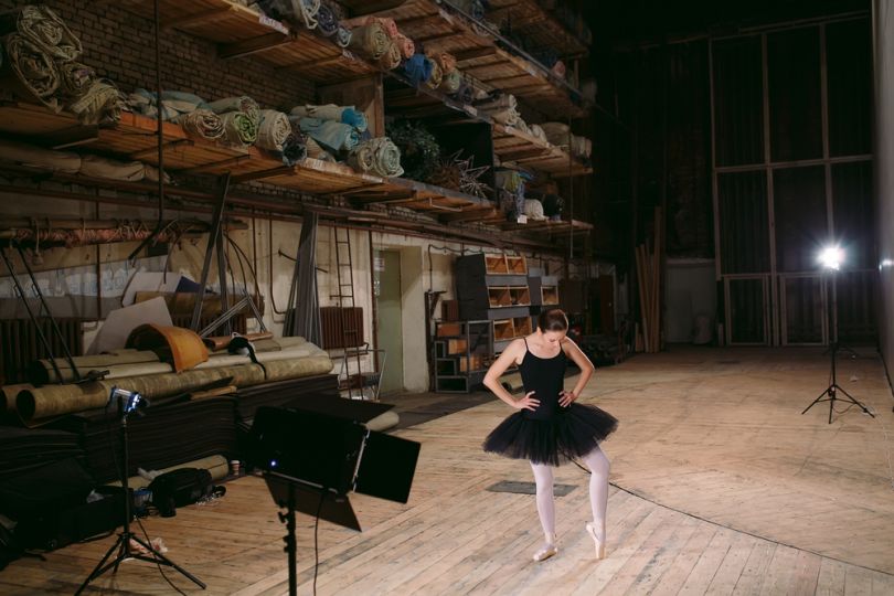 Ballerina stretching behind the scenes of the theatre