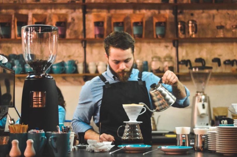 Barista pouring coffee