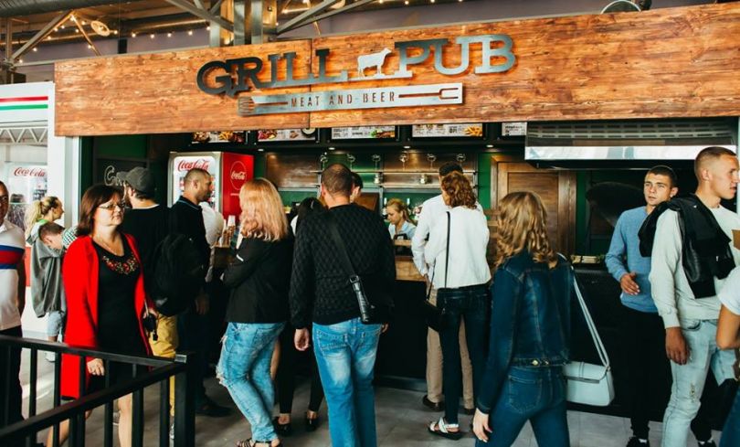 people in queue into a Grill Pub