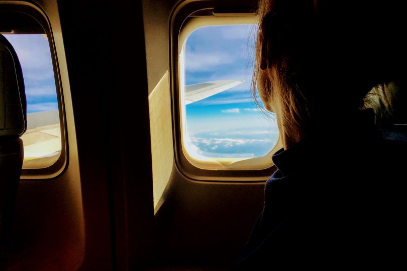 Woman watching sky from the plane window