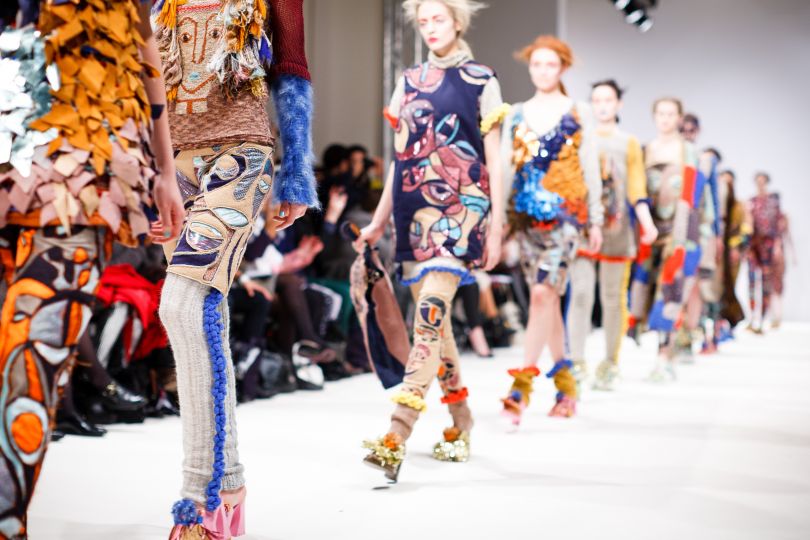 Models in colorful clothes on catwalk