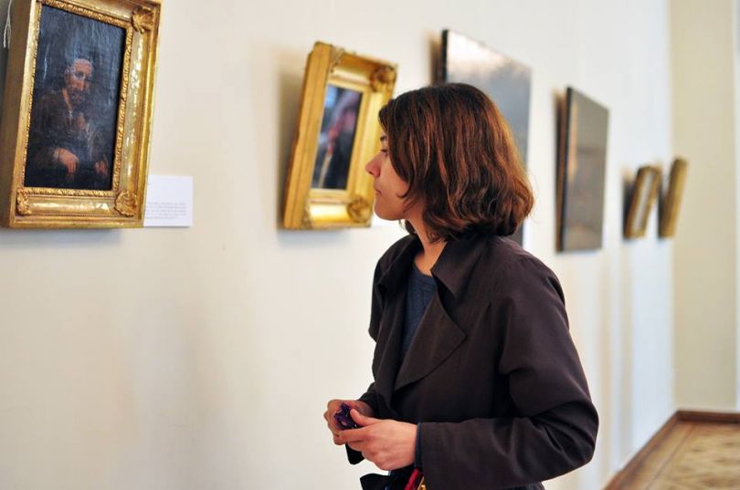 Girl viewing paintings in Taras Shevchenko Museum in Kyiv