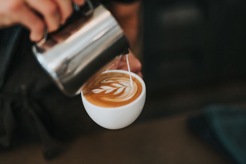 Man pouring capuccino