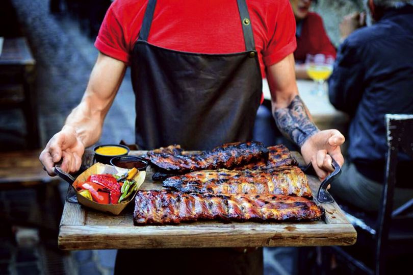 Man holding BBQ ribs