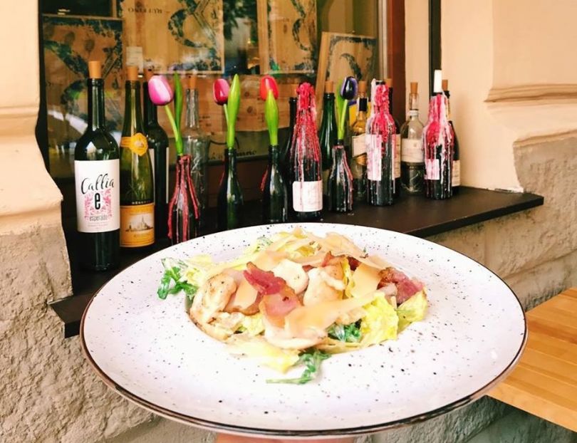 bottles of wine and dish with salad