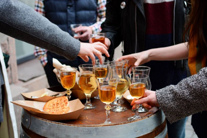 People grabbing drinks and pie