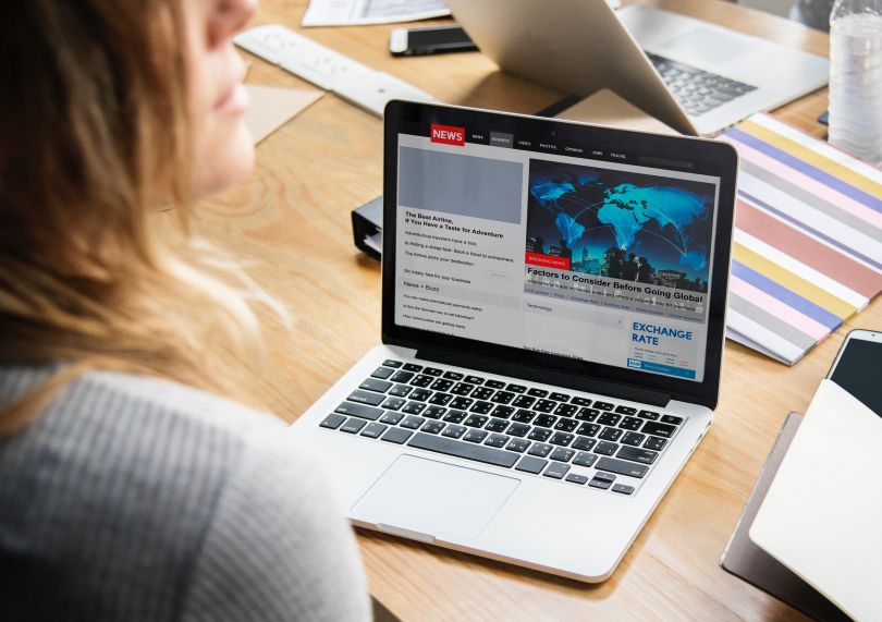 Girl watching news on the laptop