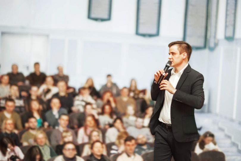 Young man speaking at a conference