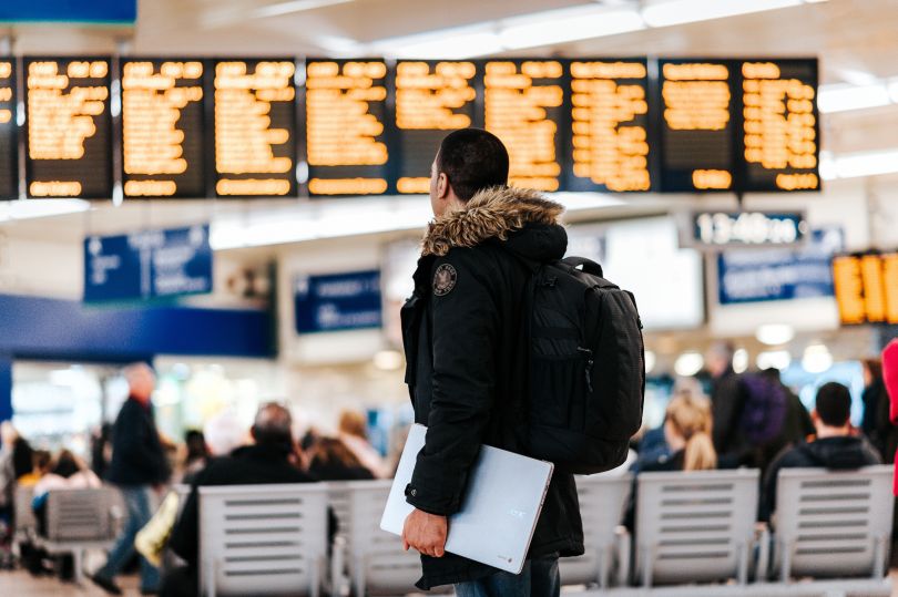 Man at the airport looking at the timetable