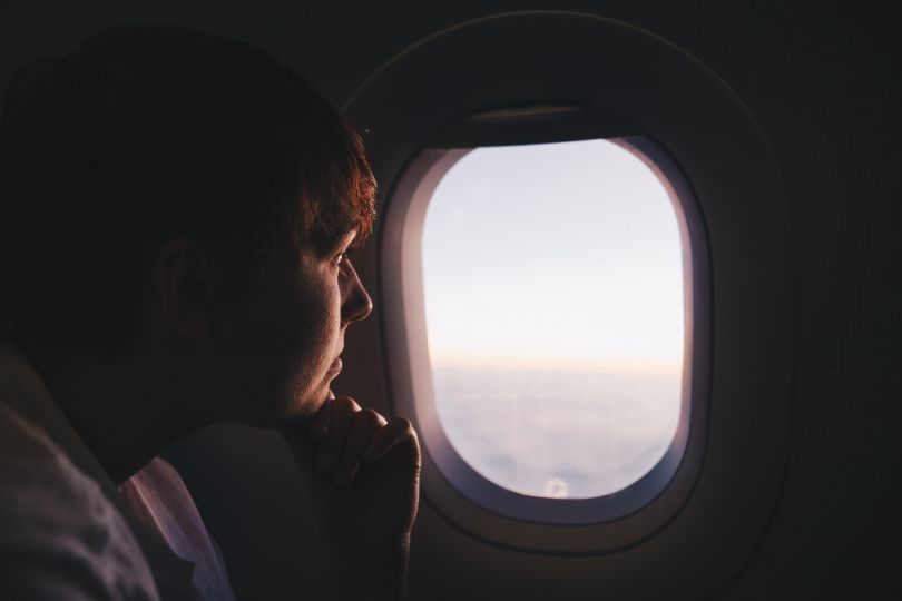 Man looking out of the airplane window