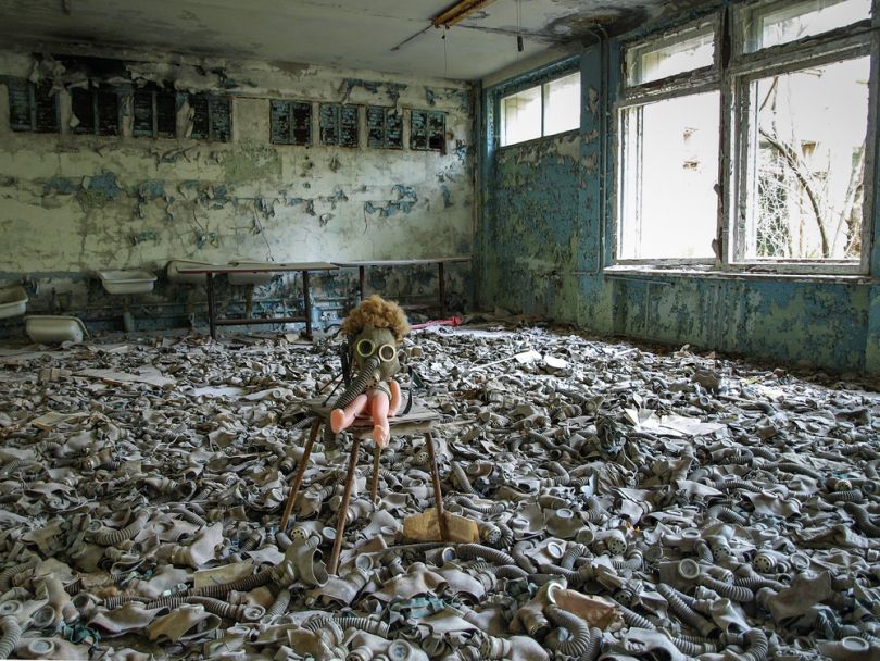 old doll and gas masks in building in chornobyl