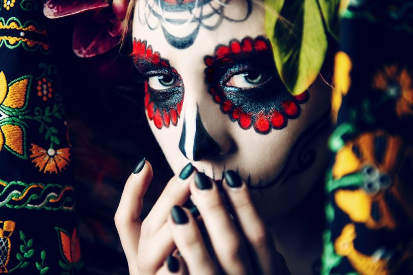 Girl in traditional Mexican Day of the Dead makeup