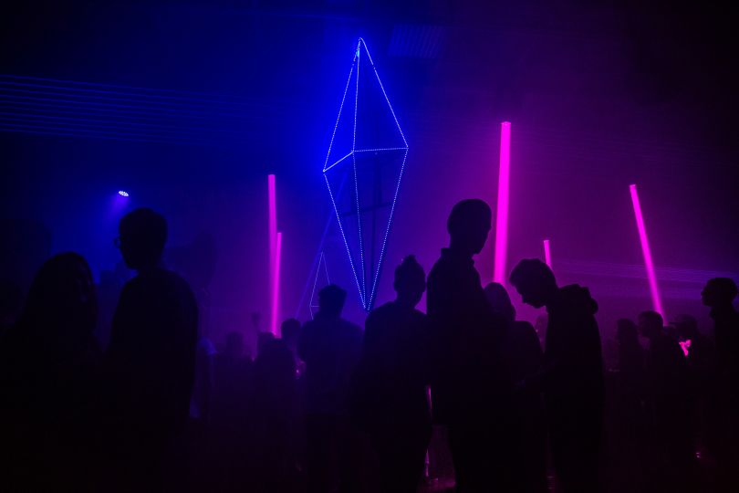 People dancing at neon disco