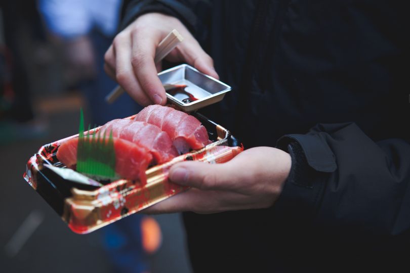 man holding sushi