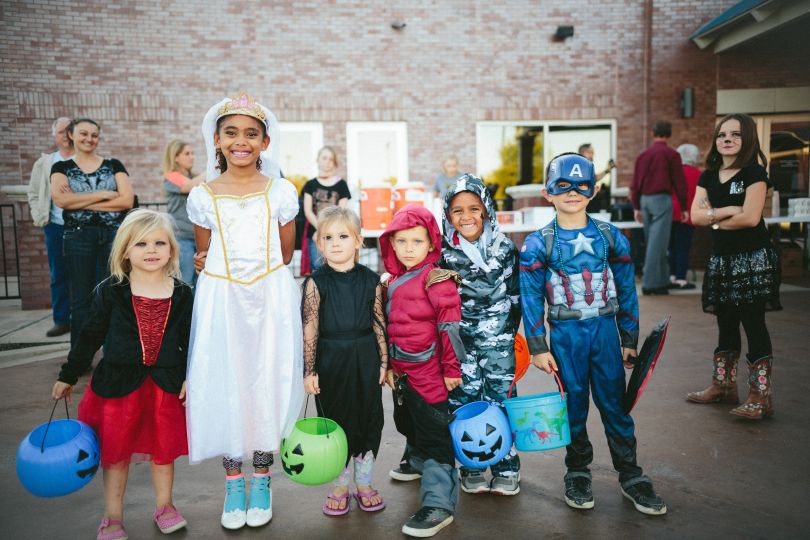 Kids in costumes celebrating Halloween