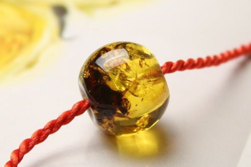 piece of amber on thread