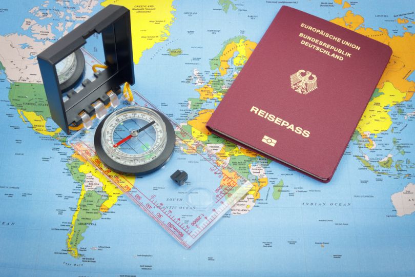 passport, compass on map