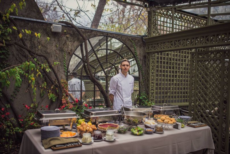 waiter near table with food