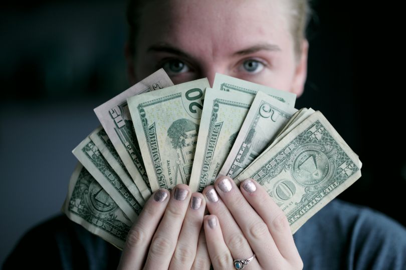 man holding money at face