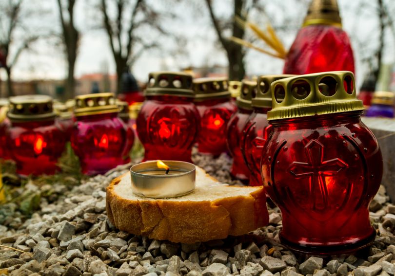 many burning candles and piece of bread