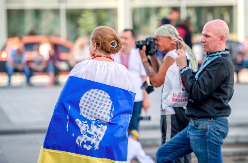 Youth in vyshyvanka carrying the flag of Ukraine