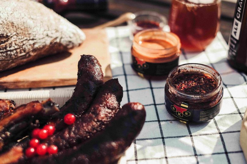 sausages, dread and sauce on table