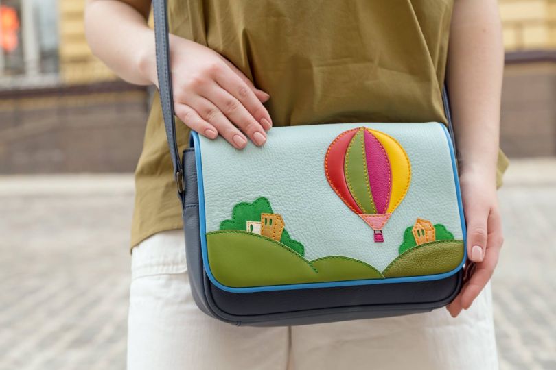 hands holding colorful bag