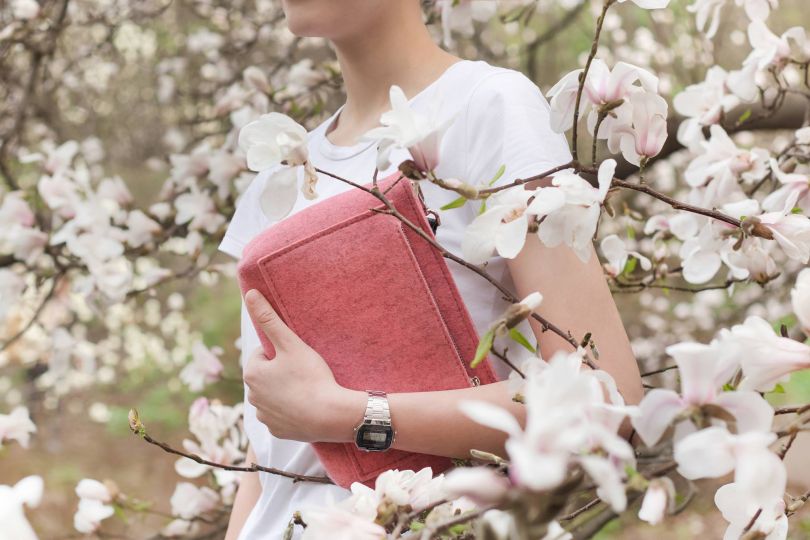 girl with rose bag in spring flowers