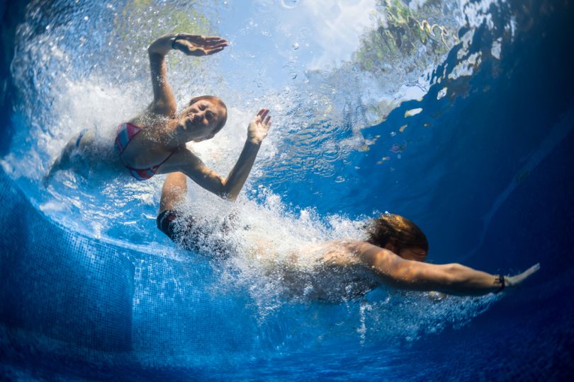 Girls diving in a pool