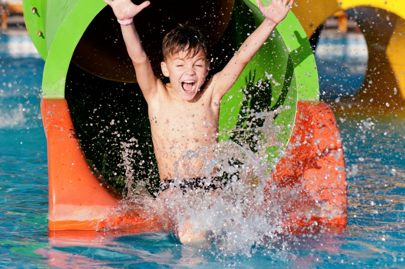 Happy boy in a water park