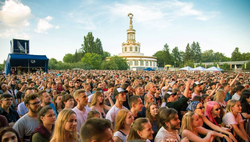crowd on festival with soviet building on the background