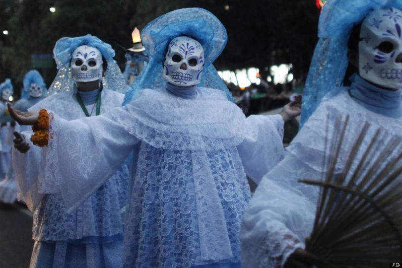 people in spooky clothes and masks