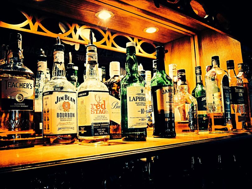 many bottles with strong alcohol on bar counter