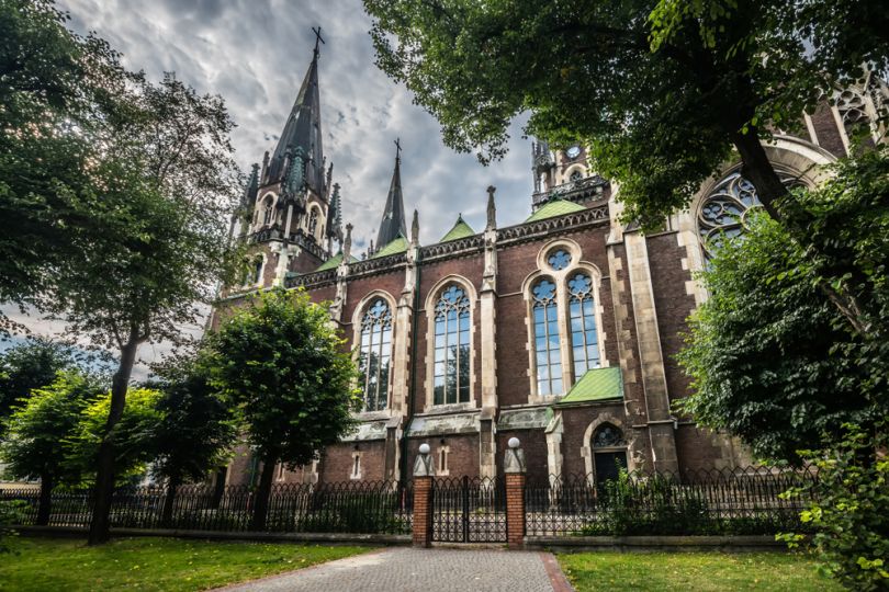 Neo-gothic building surrounded by greenery