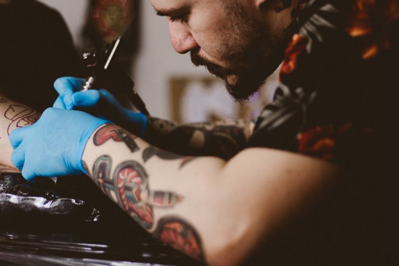 Man working on a tattoo