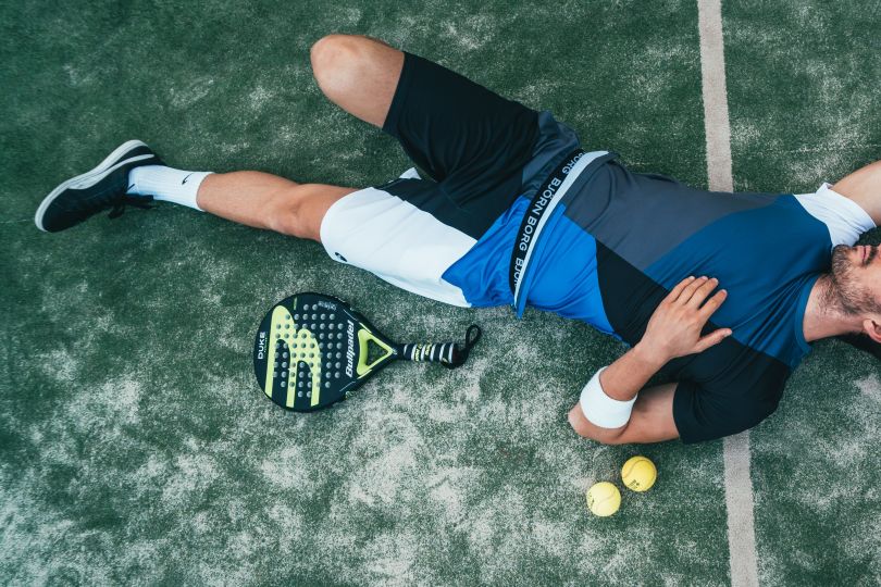 Man lying on the tennis court