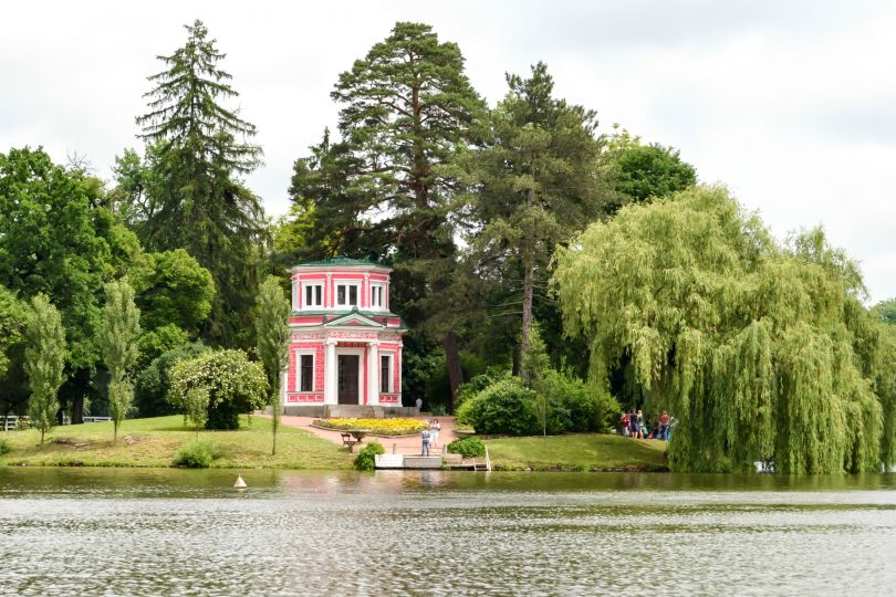 pink building by lake